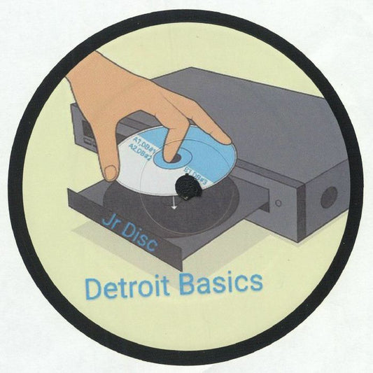 Etiqueta central lado B del vinilo JR Disc – Detroit Basics #2 mostrando mano colocando disco y diseño gráfico del sello Detroit Basics.