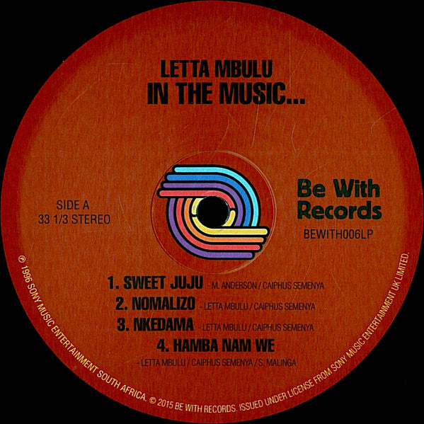 Etiqueta del lado A del vinilo Letta Mbulu – In The Music... The Village Never Ends de Be With Records. Texto impreso: lista de 4 temas, duración 33 1/3 RPM.