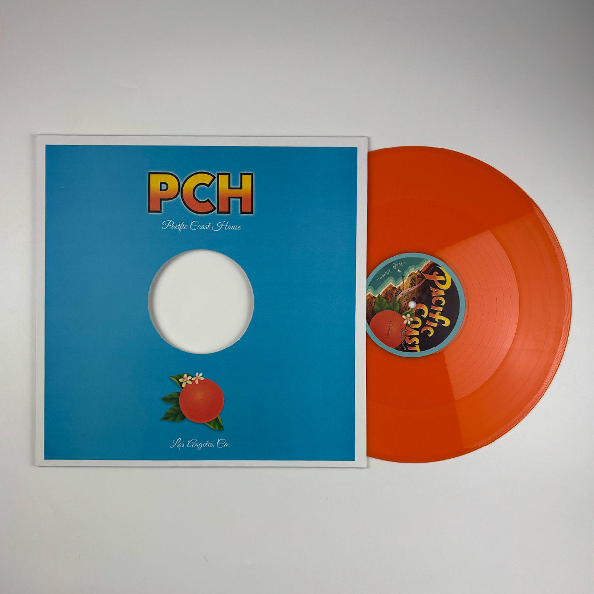 Vinilo naranja 12" remasterizado de The Coastal Commission Feat. Cpen – Rhodes Through Space junto a su funda Pacific Coast House Recordings.