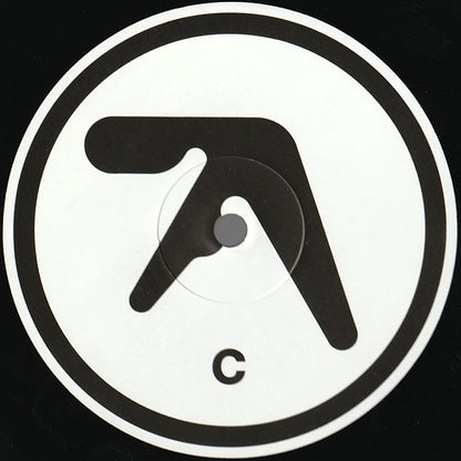 Centro del vinilo Aphex Twin – Selected Ambient Works 85-92, lado C, con diseño minimalista en blanco y negro y letra C destacada.