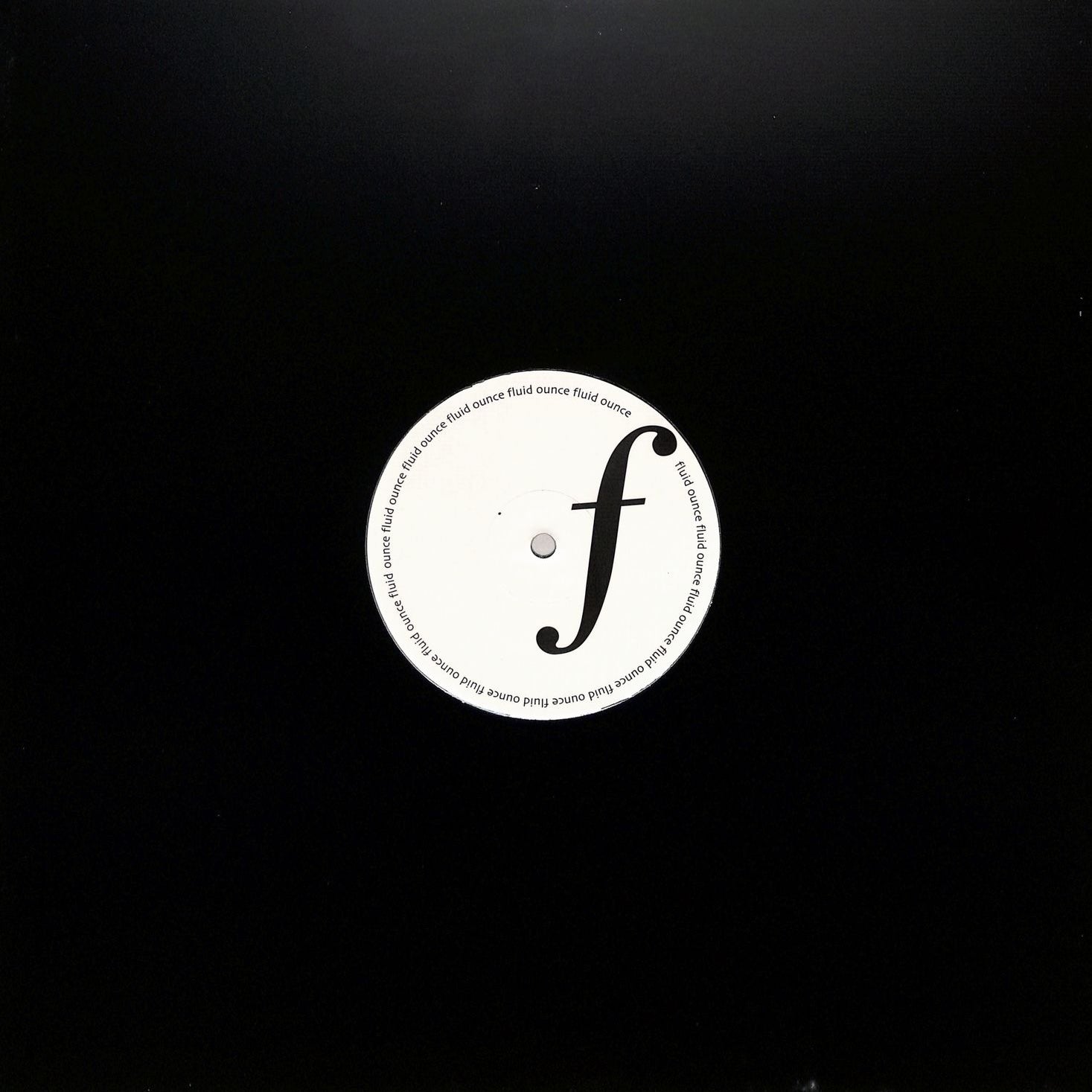 Portada del vinilo Jimi Tenor – Release Me! en 12" por Fluid Ounce, funda negra con orificio central que deja ver la etiqueta del lado A.