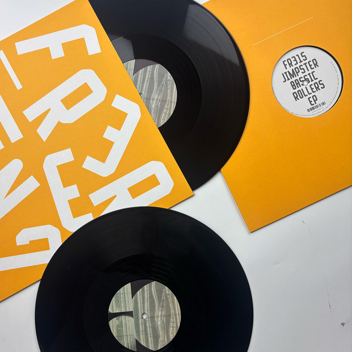 Contraportada de vinilo Jimpster – Bassic Rollers EP 12" EP con discos parcialmente fuera de fundas naranjas Freerange Records.