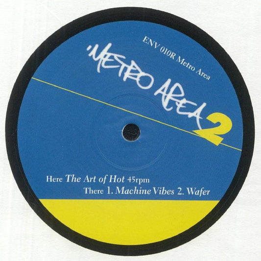Portada del vinilo Metro Area – Metro Area 2, lanzado por Environ en formato 12". Diseño en azul y amarillo con el logo de la banda. Texto impreso: “The Art of Hot”, “Machine Vibes” y “Wafer” indicando la lista de canciones.