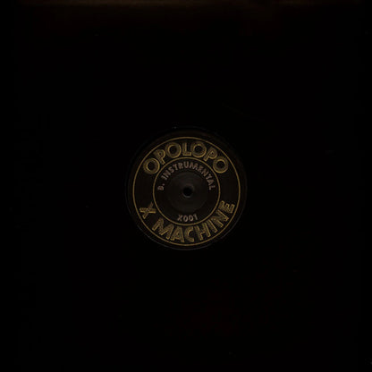 Funda negra del vinilo Opolopo – X Machine en 12" de Toolroom Records mostrando la etiqueta central con la cara B.