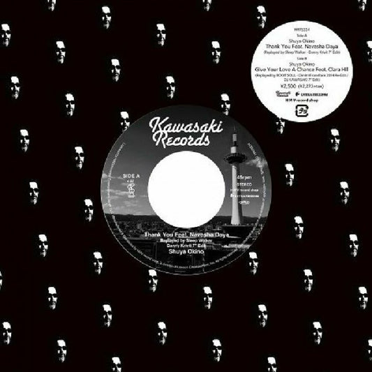 Vinilo 7" de Shuya Okino – Thank You (Danny Krivit, Dimitri From Paris / DJ Kawasaki Mixes) con etiqueta Kawasaki Records lado A a 45 RPM y pista Thank You feat. Navasha Daya sobre funda negra con patrón de rostros.