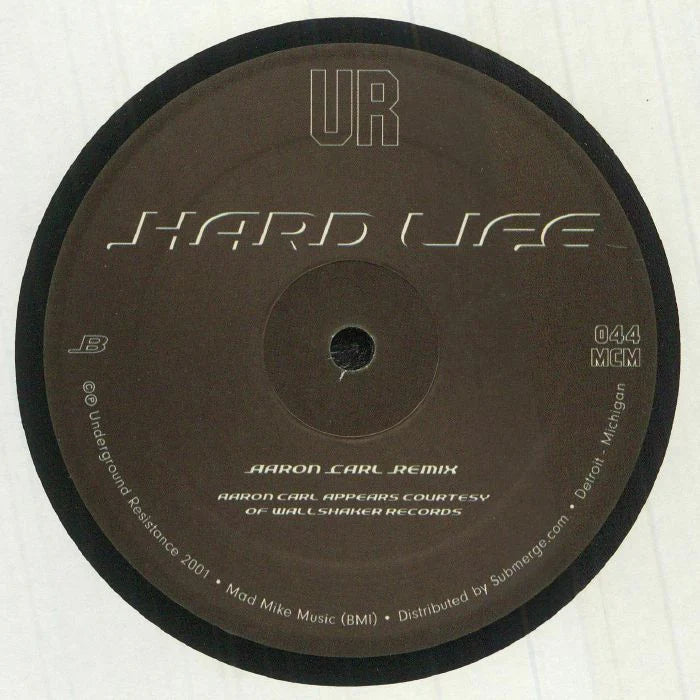 Lado B del vinilo UR – Hardlife, reedición 12" de Underground Resistance con Aaron Carl Remix destacado y catálogo 044 MCM en la etiqueta central.